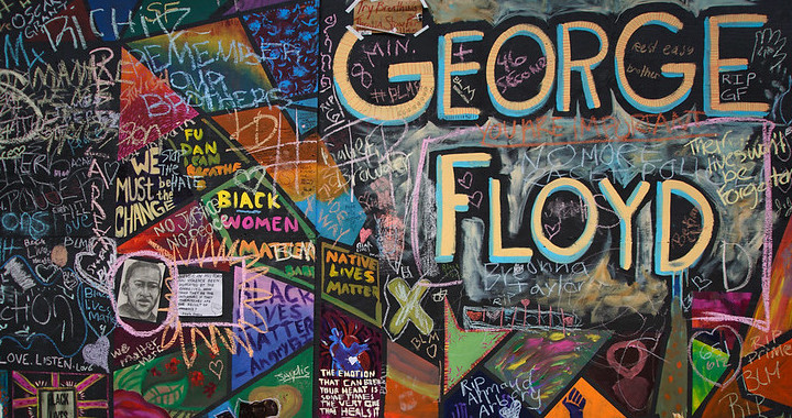 Public art, including memorials to George Floyd, adorn the side of the Apple store's black plywood walls in downtown Portland, Oregon